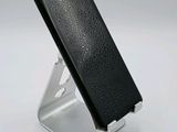 a close up of a cell phone on a stand on a white surface