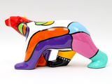 brightly colored ceramic figurine of a bear on a white background