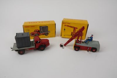 two toy trucks that are sitting next to each other
