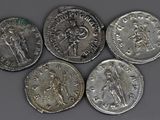 six ancient roman coins, one of which is a woman and one of which is a man