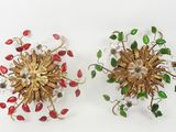 pair of gold and red flower brooches on white background