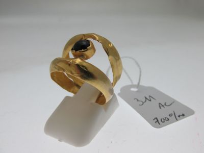 a gold ring with a black stone on it