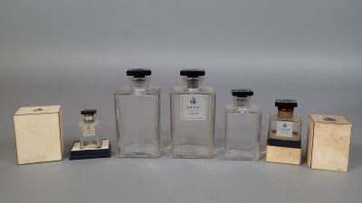 several bottles of different sizes and shapes are lined up on a table