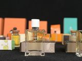 three bottles of perfume sitting next to each other on a table
