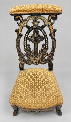 an antique chair with a gold upholstered seat and gold upholstered cushion