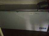 a small freezer in the corner of a room