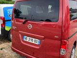 a red van that is parked next to a white van
