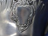 a close up of a silver object with a heart on it
