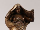bronze statue of a woman holding a flower on a marble base