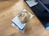 a bag of paper sitting on the floor next to a laptop
