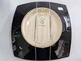 a black and white plate with a white label on it