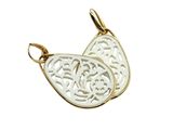 a close up of a white and gold pendant on a white background