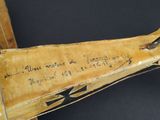 a piece of wood with writing on it and a piece of wood with writing on it