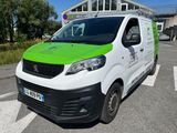 the green and white van is parked on the side of the road