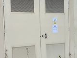 two doors on the side of a building that has a sign on it