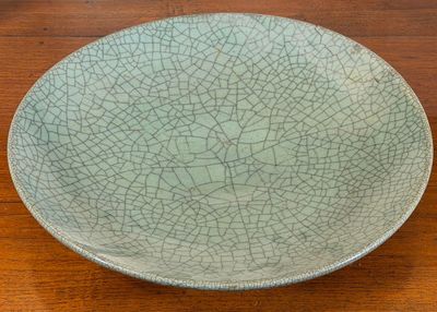 a cracky plate sitting on a wooden table