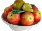 a bowl of apples and pears on a white plate