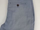 the back of a pair of light blue pants on a white background