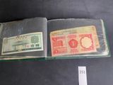 an open book with a picture of a chinese currency note and a chinese currency note