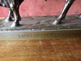 a statue of a man riding a horse on a wooden table