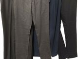 three men ' s pants hanging on a clothes line on a white background