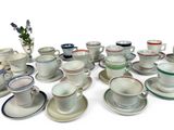 a lot of cups and saucers sitting on a table
