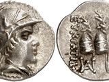 a silver coin with an image of a woman and a man on it