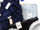 three pairs of men ' s underwear sitting on top of a white table