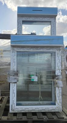 a picture of a window on a pallet in front of a building
