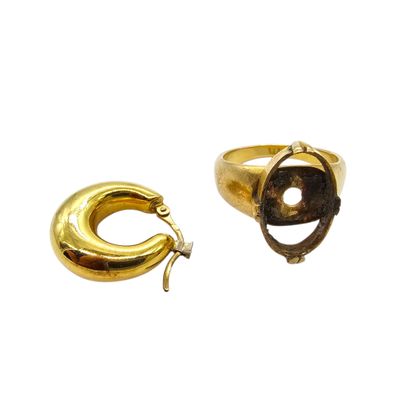 an image of a pair of gold rings with a stone in the middle