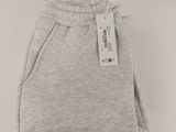 a close up of a pair of grey sweat pants with a tag on it