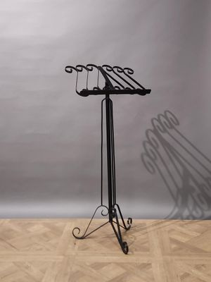 a black metal stand with a pair of glasses on it