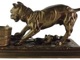 bronze statue of a dog with a basket of mice on it