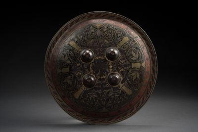 an image of a bronze plate with a circular design on it