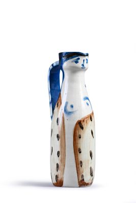 a white and blue vase with a dog on it
