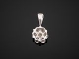 a white gold and diamond pendant on a black background