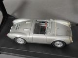 a silver model of a car on display on a table