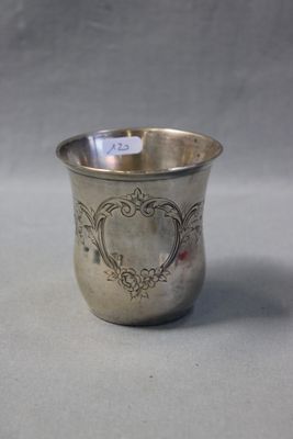 a silver cup that is sitting on a table