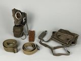 a gas mask, belt, and other items on a white surface