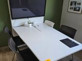 a white table with a computer on top of it
