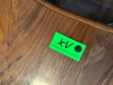 a green sticker on the back of a wooden chair