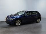 the blue car is parked in a room with a white wall