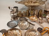 a lot of silverware on a table with a rope