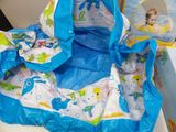 a blue and white bag with a baby in it on a table