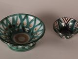 a small bowl and a small bowl sitting on a table