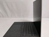 an open laptop computer sitting on top of a white surface