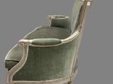 a green and white chair sitting on top of a black floor