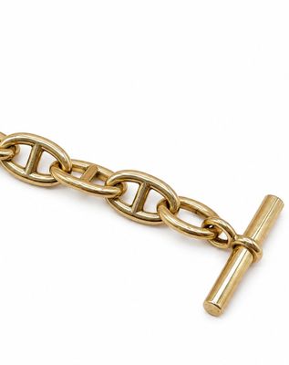 une image montrant un gros plan d'une chaîne sur laquelle est accrochée une croix