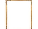 a gold frame on a white wall with a white background
