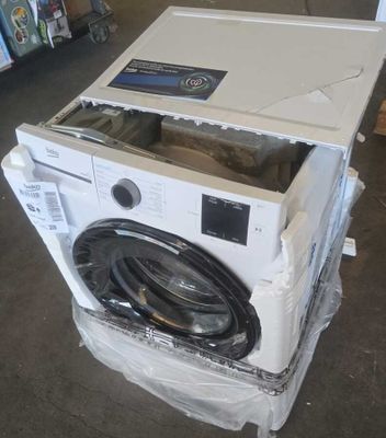 une machine à laver posée sur un carton